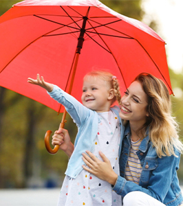 mother and daughter using umbrella